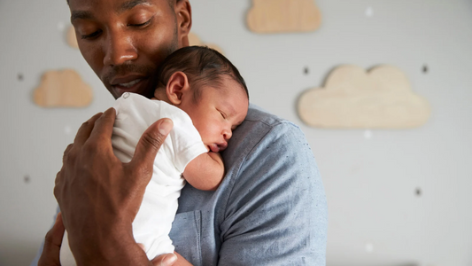 Father holding a his newborn.