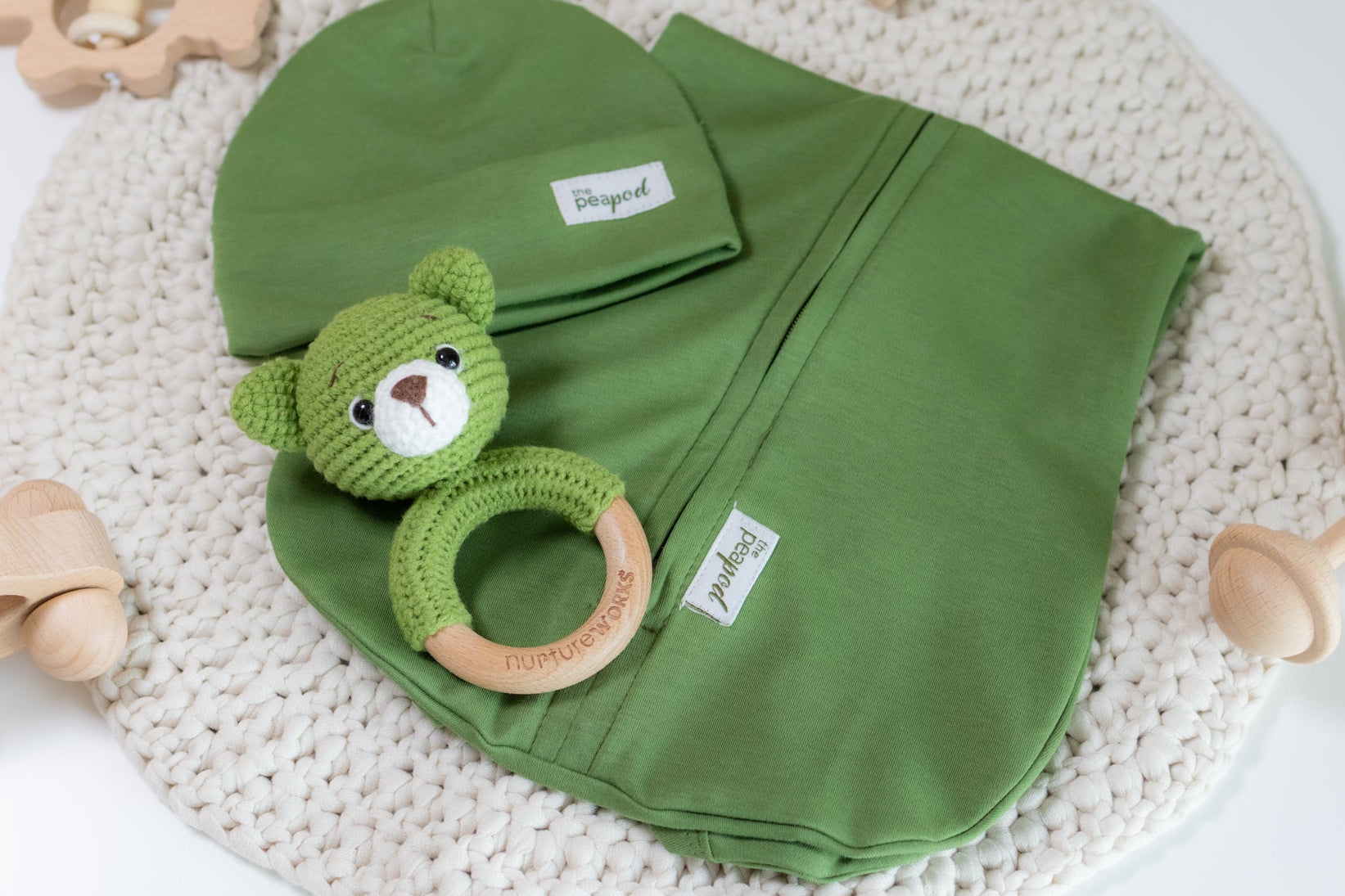 Green baby sleep sack set with matching hat and crochet bear rattle.