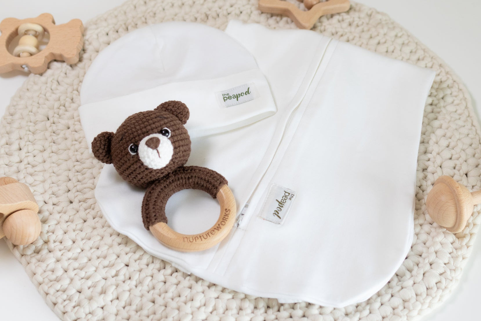 White baby sleep sack set with matching hat and crochet bear rattle.