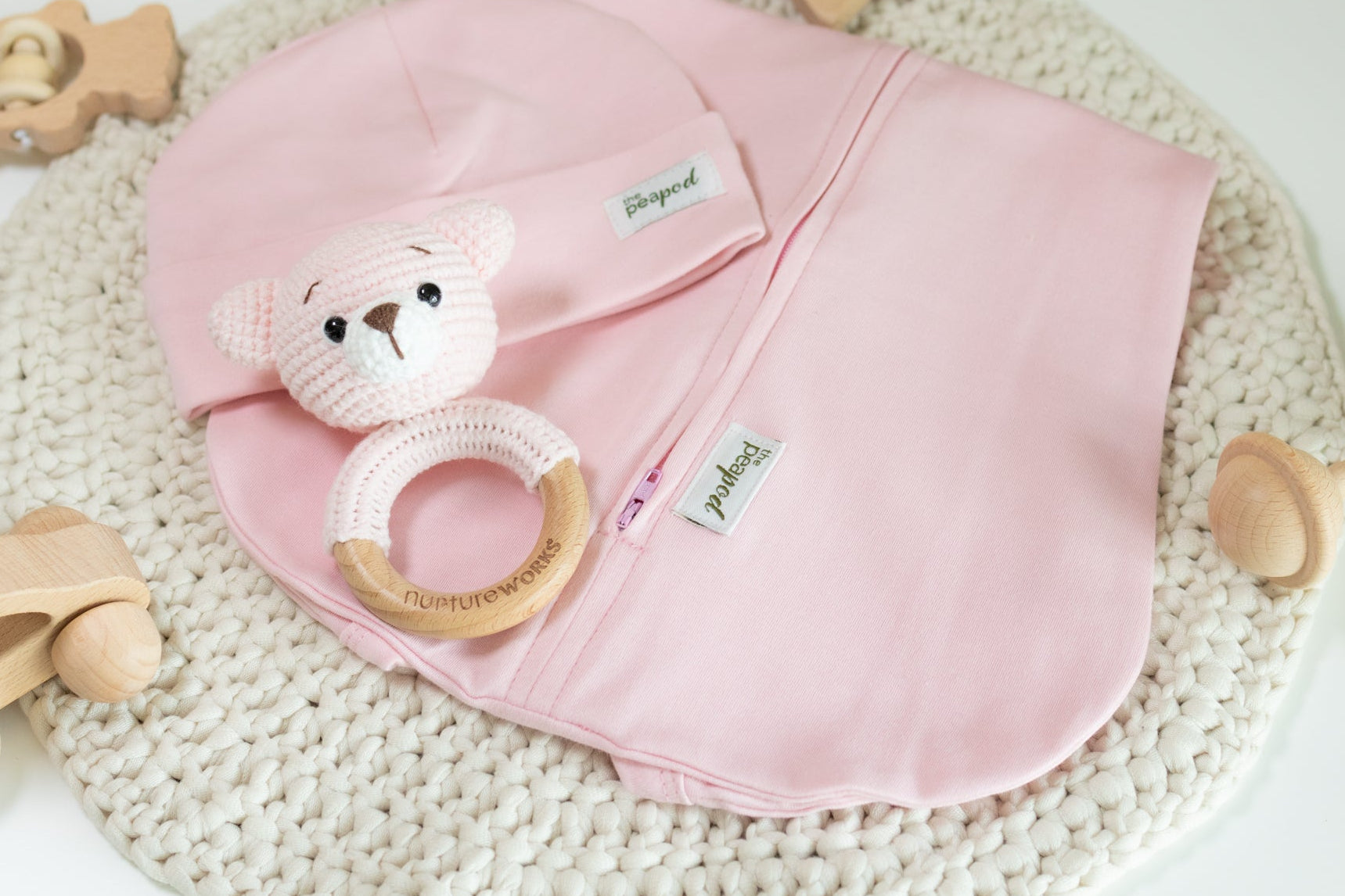 Pink baby sleep sack set with matching hat and crochet bear rattle.
