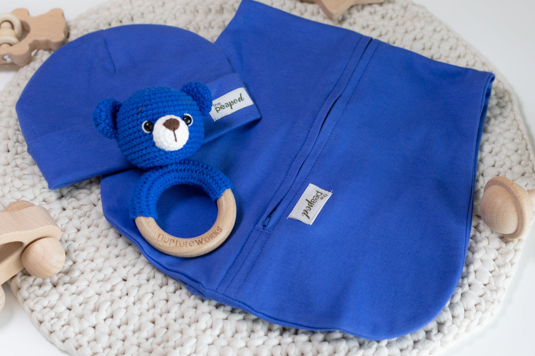 Blue baby sleep sack set with matching hat and crochet bear rattle.”