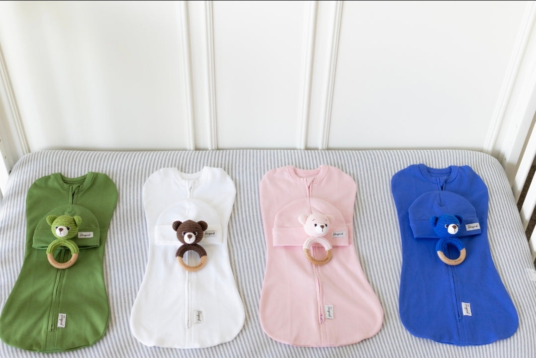 Four baby sleep sack sets with matching hats and crochet rattles.