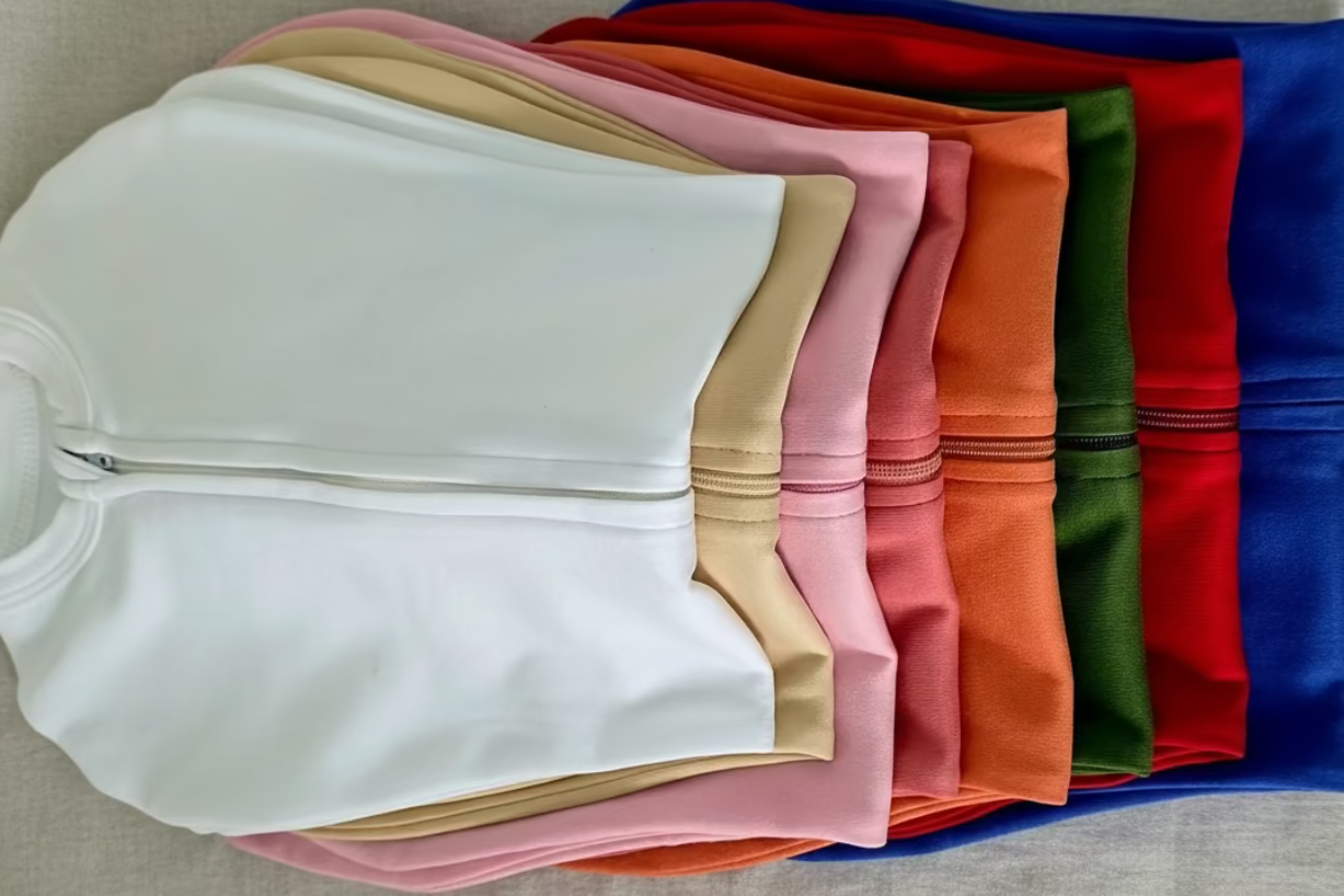 Stack of colorful sleep sacks on a neutral background